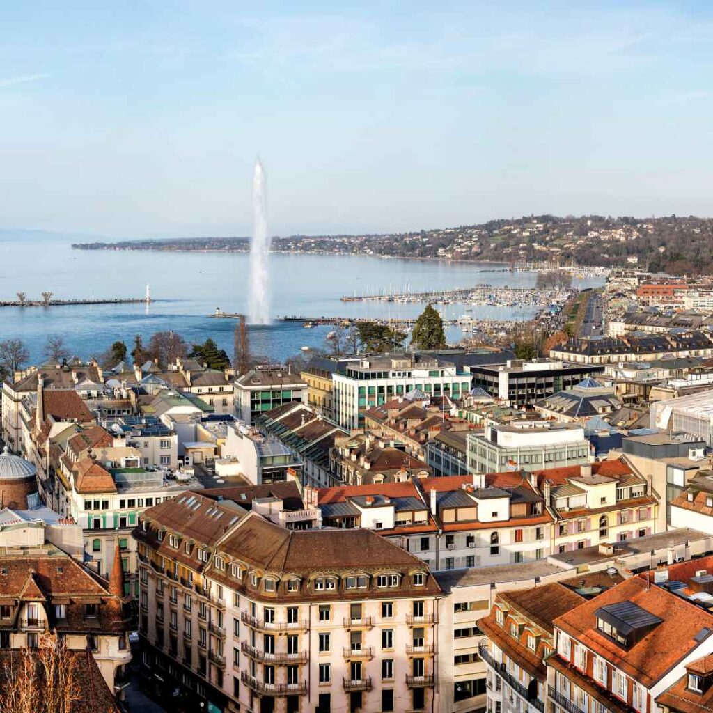 Aerial view of Geneva’s city center with Lake Geneva and the Jet d’Eau fountain in the background, representing the location of Santa Fe Relocation’s Geneva team.