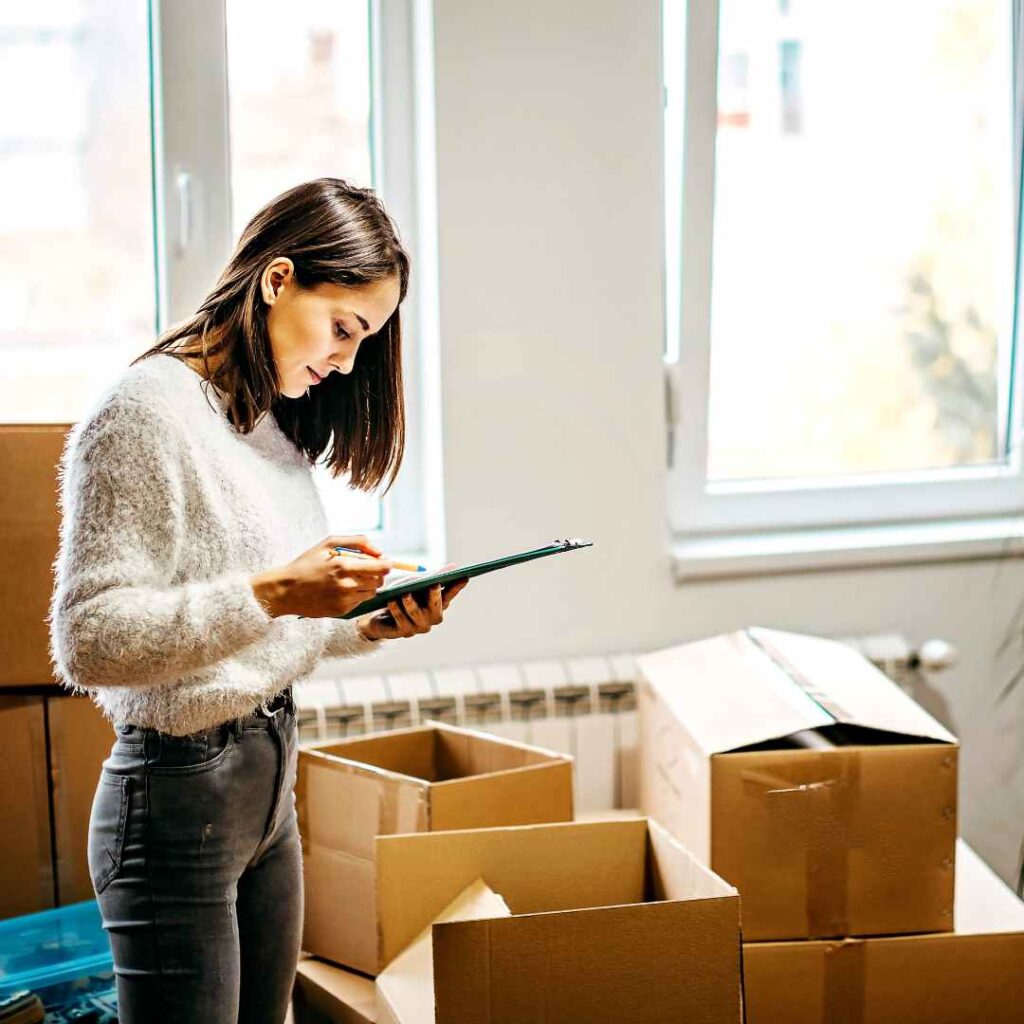 Woman organising her moving checklist provided by Santa Fe Relocation to make the whole process easy and smooth.